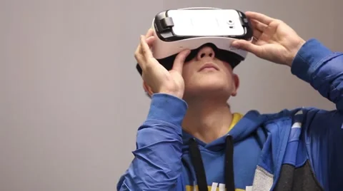 Virtual reality game. Young man playing with virtual reality glasses Stock Footage 60789226