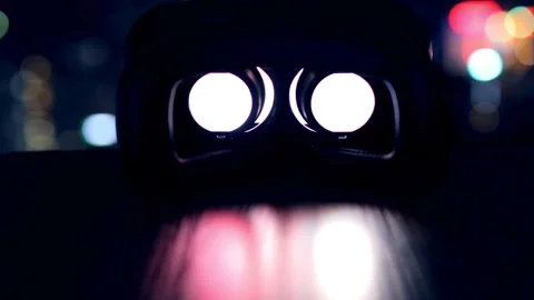 Virtual reality goggles with colorful light reflections at night Stock Footage 332283431