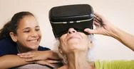 Virtual Reality Happy Grandmother And Young Girl Playing Together Stock Photos