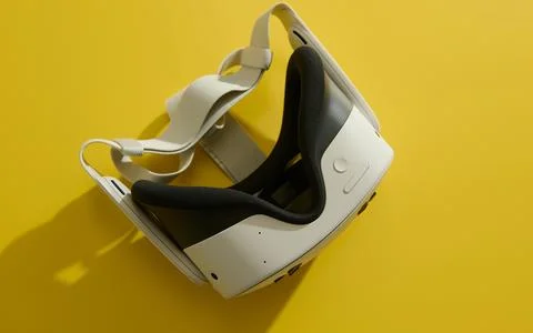 Virtual Reality Headset On Bright Yellow Background For Immersive Tech Demo.. Stock Photos