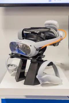 Virtual reality headset displayed on a stand with controllers showcasing mo.. Stock Photos