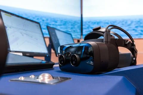 Virtual reality headset sits on a ship bridge console Foto stock