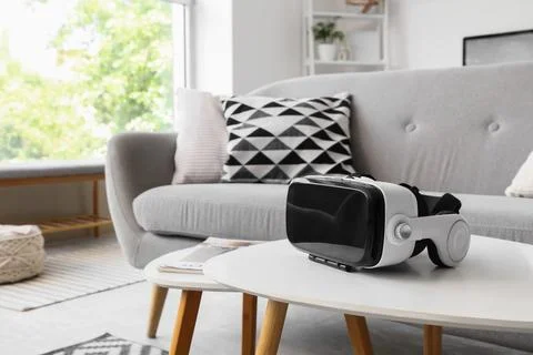 Virtual reality headset on white table in modern living room Stock Photos