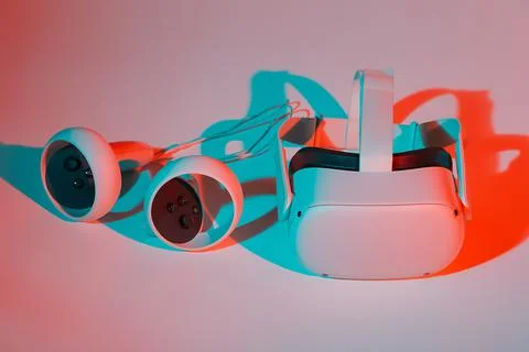Virtual reality helmet and controllers on white background in neon light Stock Photos