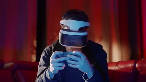Virtual Reality Man using Smartphone alone in his room with VR goggles on Stock-Footage 258548418