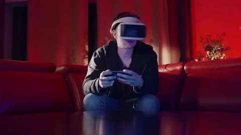 Virtual Reality Man using Smartphone in a red room Vídeo Stock 258551257