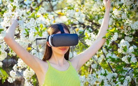 Virtual reality is truly here. Cute girl play in spring garden. Girl in virtual Stock Photos