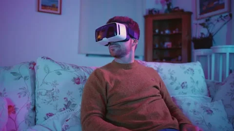 Virtual Reality VR Metaverse Headset Man Playing Games Exploring Worlds Video stock 195289750