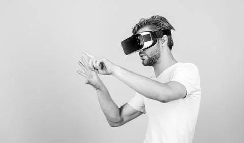 Virtual simulation. Man play game in VR glasses. Explore cyber space. Man Stock Photos