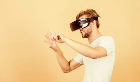 Virtual simulation. Man play game in VR glasses. Explore cyber space. Man Stock Photos