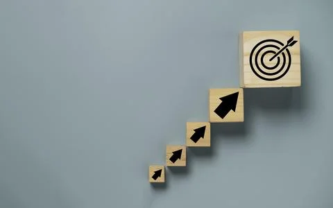 Virtual target board and arrow which print screen on wooden cube. Business .. Stock Photos