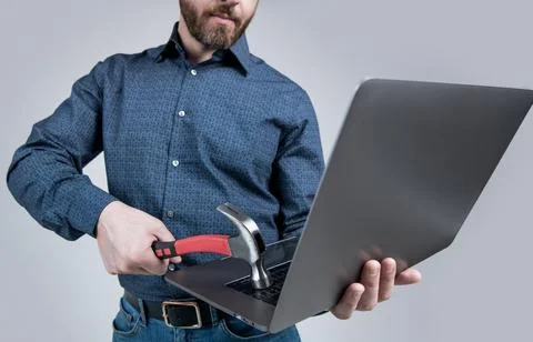 Virus attack. Man cropped view hit laptop with hammer. Virus threat. Virus Stock Photos