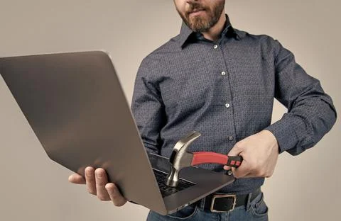 Virus attack. Man cropped view hit laptop with hammer. Virus threat. Virus Stock Photos