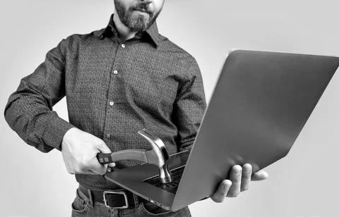 Virus attack. Man cropped view hit laptop with hammer. Virus threat. Virus Stock Photos