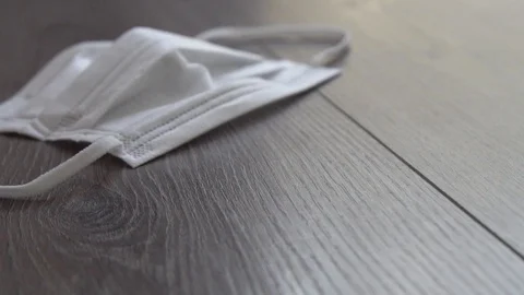 Virus protection mask falling on the ground in slow motion. Video stock 124288969