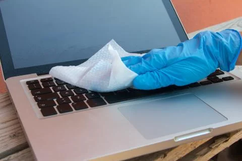 Virus sanitization on the computer keyboard with blue spray jet screen and s Stock Photos