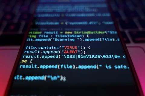 Virus on smartphone device. Programming code with Virus alert input. Malware and Foto stock