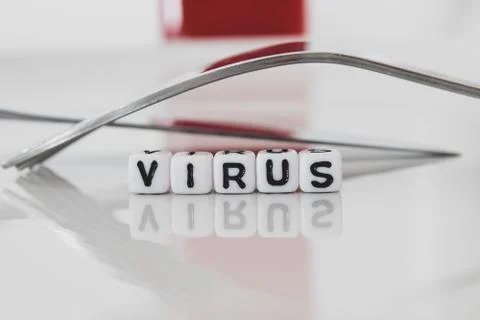 Virus work in white plastic letters on plate with form and red bottle in the  Stock Photos