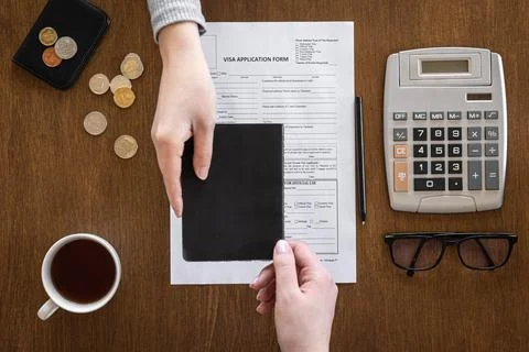 Visa application form on a wooden table, visa processing, registration, flat lay Stock Photos