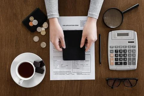 Visa application form on a wooden table, visa processing, registration, flat lay Stock Photos