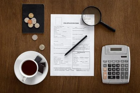 Visa application form on a wooden table, visa processing, registration, flat lay Stock Photos