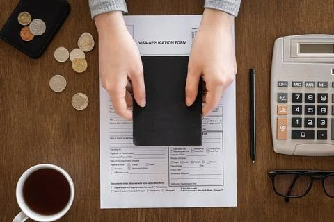 Visa application form on a wooden table, visa processing, registration, flat lay Stock Photos