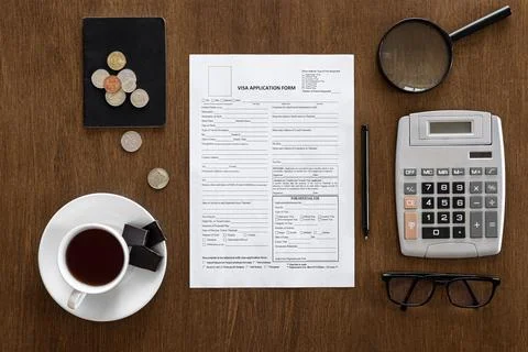 Visa application form on a wooden table, visa processing, registration, flat lay Stock Photos