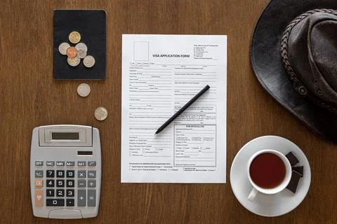 Visa application form on a wooden table, visa processing, registration, flat lay Stock Photos