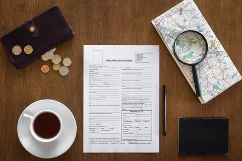 Visa application form on a wooden table, visa processing, registration, flat lay Stock Photos
