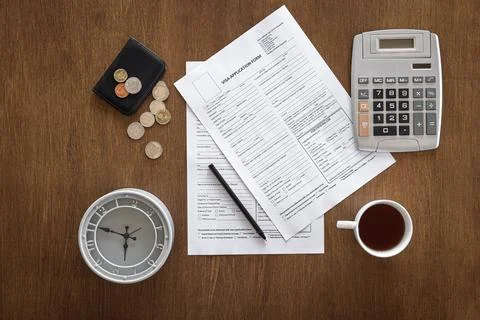 Visa application form on a wooden table, visa processing, registration, flat lay Stock Photos