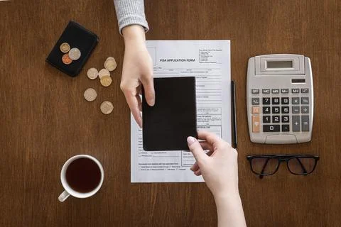 Visa application form on a wooden table, visa processing, registration, flat lay Stock Photos