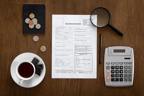 Visa application form on a wooden table, visa processing, registration, flat lay Stock Photos