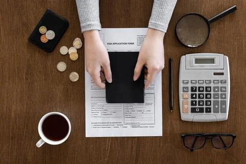 Visa application form on a wooden table, visa processing, registration, flat lay Stock Photos