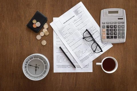 Visa application form on a wooden table, visa processing, registration, flat lay Stock Photos