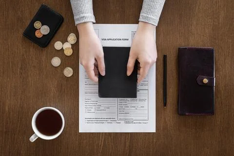 Visa application form on a wooden table, visa processing, registration, flat lay Stock Photos