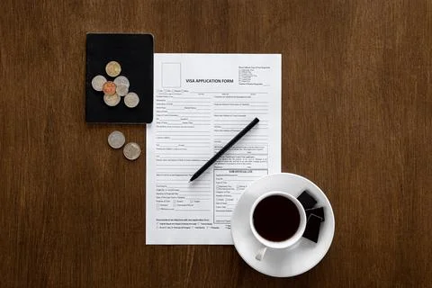Visa application form on a wooden table, visa processing, registration, flat lay Stock Photos