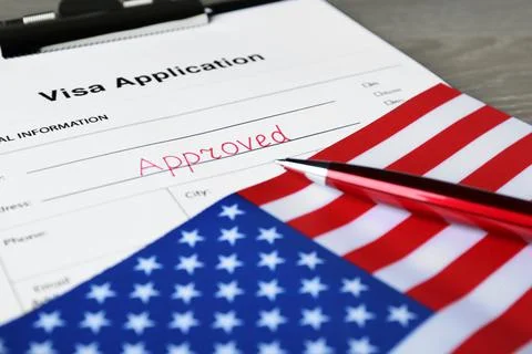 Visa application form with word Approved, American flag and pen on table, clo Foto stock