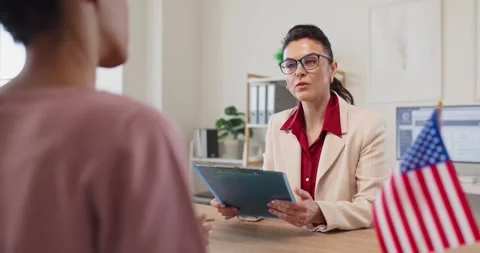 Visa application review with immigration consultant and client in modern office Stock Footage 340511669
