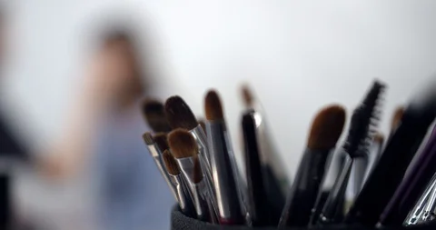 Visagiste applying makeup on models face Stock Footage 126353526