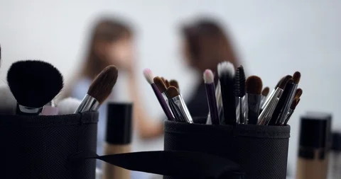 Visagiste applying makeup on models face Stock Footage 126354093