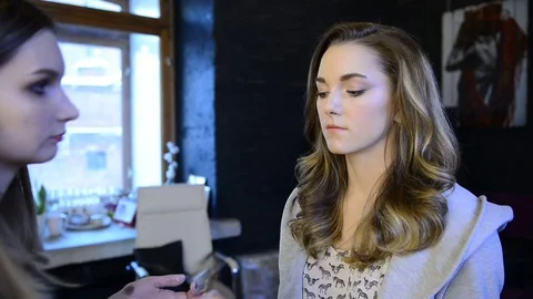 Visagiste does make up for model in beauty studio Stock Footage 74153713