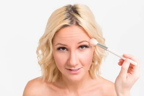 Visagiste doing makeup on the face of the bride Stock Photos