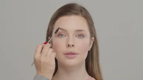 Visagiste using comb for eyebrows.  Combing eyebrows using combing brush. Mak Stock Footage 201353953