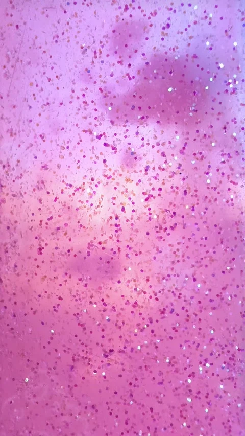 Viscous liquid with pink glitter particles flows down. Abstract magic background Stock Footage 305055376