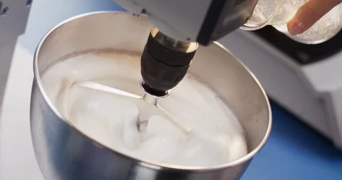 Viscous transparent liquid being mixed with white substance Stock Footage 105418898