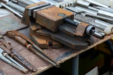 Vise and various tools on a workbench Stock Photos