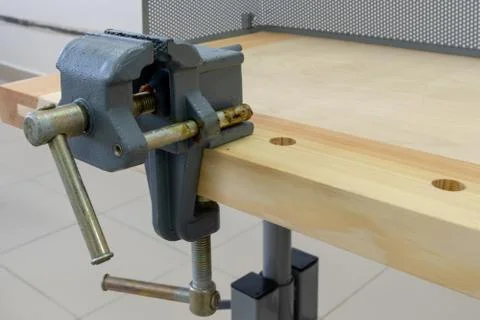 Vise attached to the workbench. Workplace of a carpenter. Close-up. School or Stock Photos