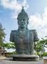 Vishnu monument close up at sunny day with blue sky and moving clouds in Bali Photo