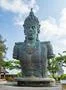 Vishnu monument close up at sunny day with blue sky and moving clouds in Bali Photo