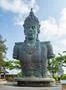 Vishnu monument close up at sunny day with blue sky and moving clouds in Bali Photo
